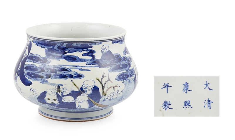 LOT 153 | BLUE AND WHITE AND UNDERGLAZE RED 'EIGHTEEN ARHATS' CENSER | KANGXI MARK | 康熙款 青花釉裏紅十八羅漢紋香爐 the bulbous body rising from an everted foot to a flared rim, painted with the Eighteen Arhats on land, sea, and sky, partly decorated with underglaze red, the base inscribed with a six-character Kangxi mark in underglaze blue (Qty: 1) 21.5cm diameter | £300 - £500 + fees